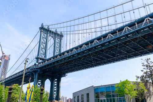 Side view of Manhattan Bridge structure and New York buildings