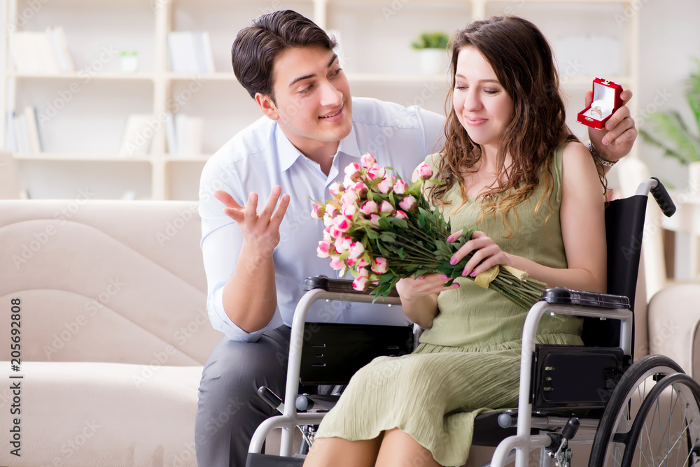Man making marriage proposal to disabled woman on wheelchair Man making marriage proposal to disabled woman on wheelchair