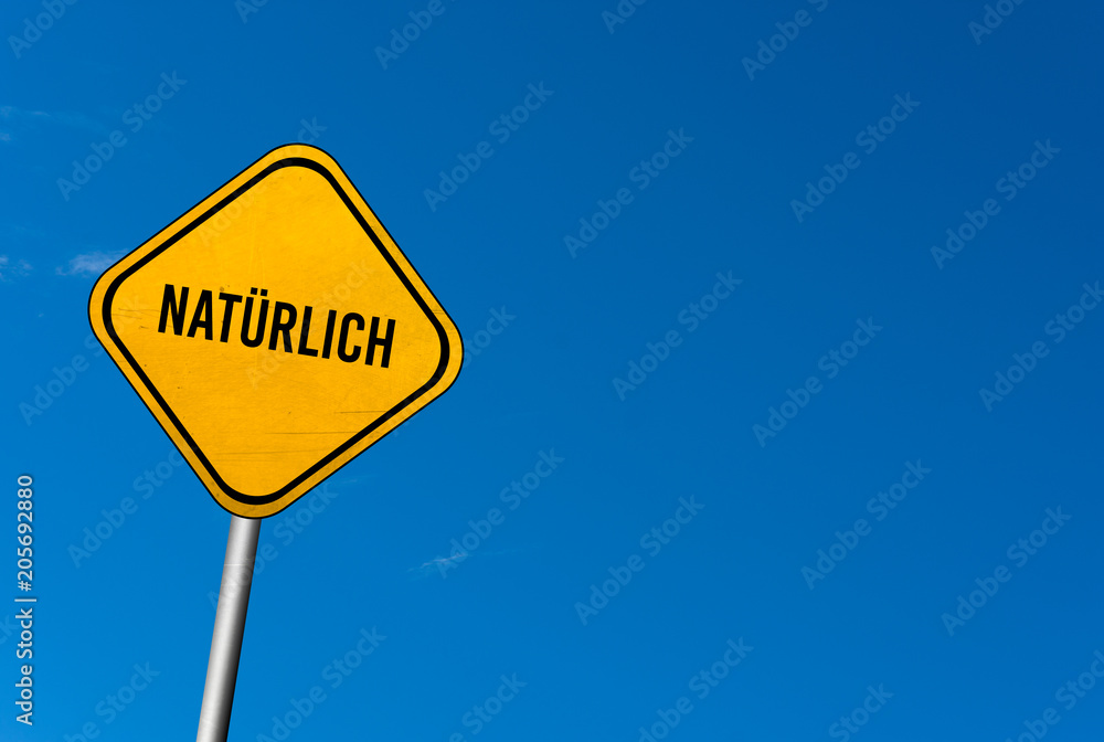 Natürlich - yellow sign with blue sky Natürlich - yellow sign with blue sky
