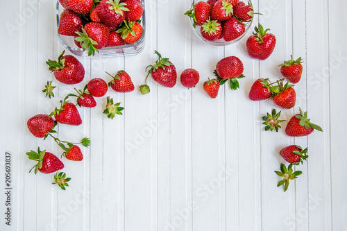 Fresh strawberries in a bowl on a white background.