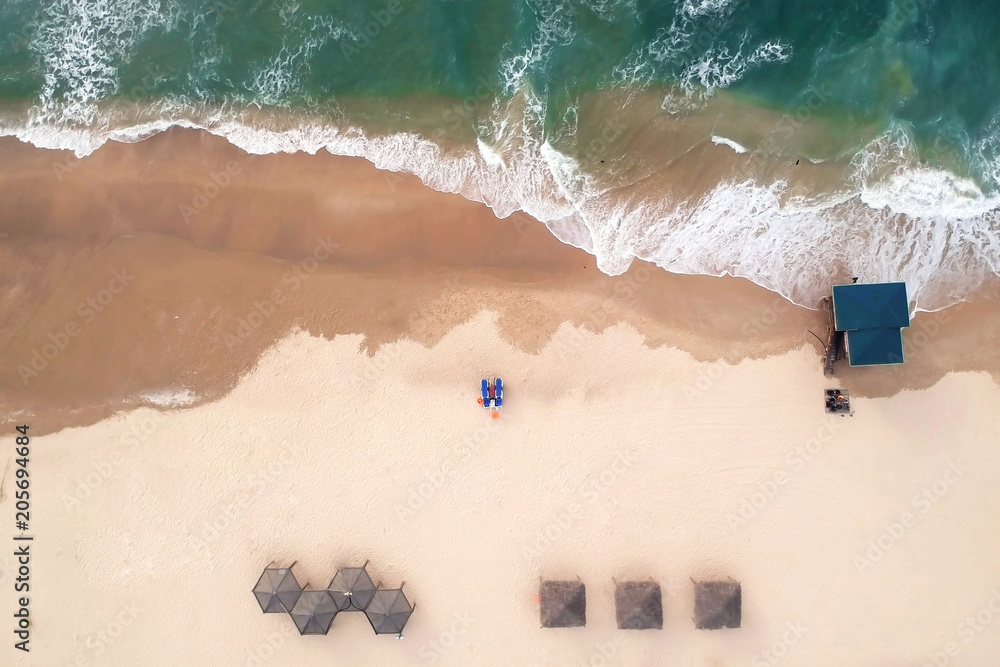 Naklejka premium Aerial view of the beach. The Mediterranean Sea, Israel..The house of the rescuer, umbrellas, sand, chaise longue..&nbsp; The eyes of the sky, another view, aerial photography