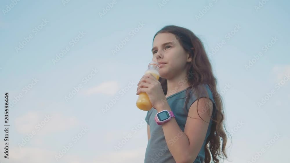 little girl drinks with plastic bottles slow motion video. girl teenager drinks juice and water exercise sport smart lifestyle the clock little girl drinks with plastic bottles slow motion video. girl teenager drinks juice and water exercise sport smart lifestyle the clock