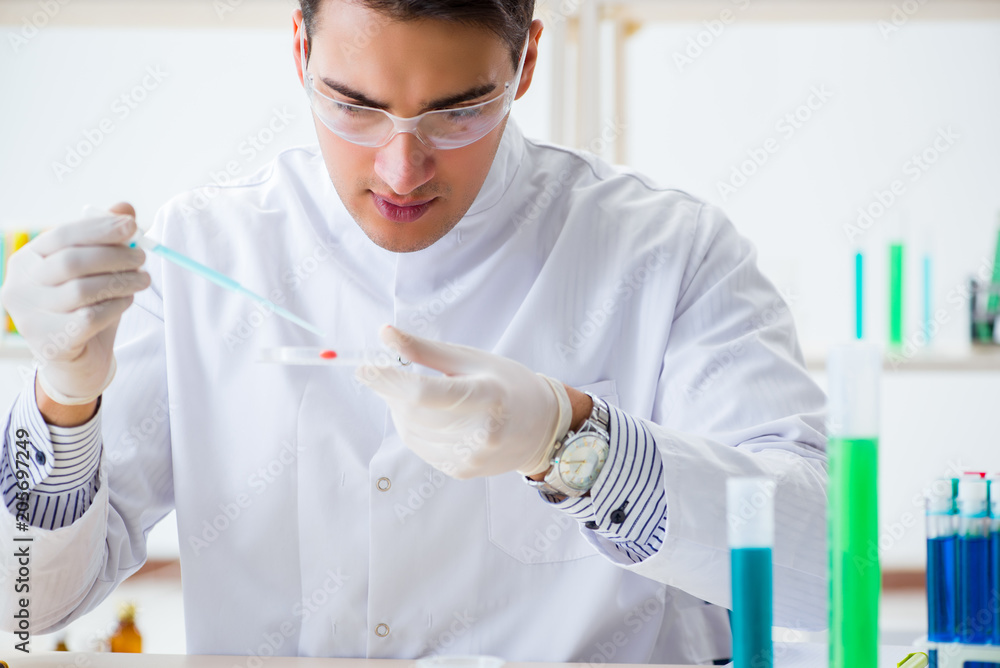 Male chemist working in lab Male chemist working in lab