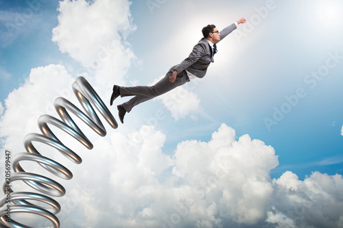 Photography Businessman jumping from spring in promotion concept