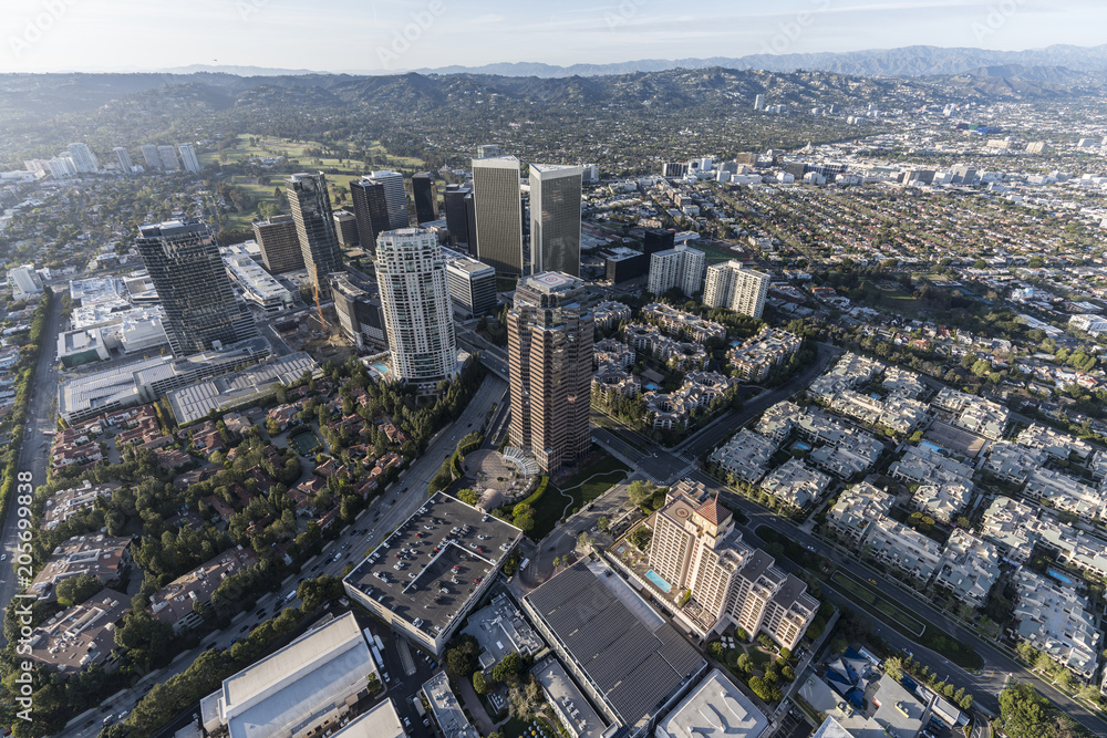 Aerial view of Los Angeles Century City towers with Beverly Hills and the Santa Monica Mountains in background.