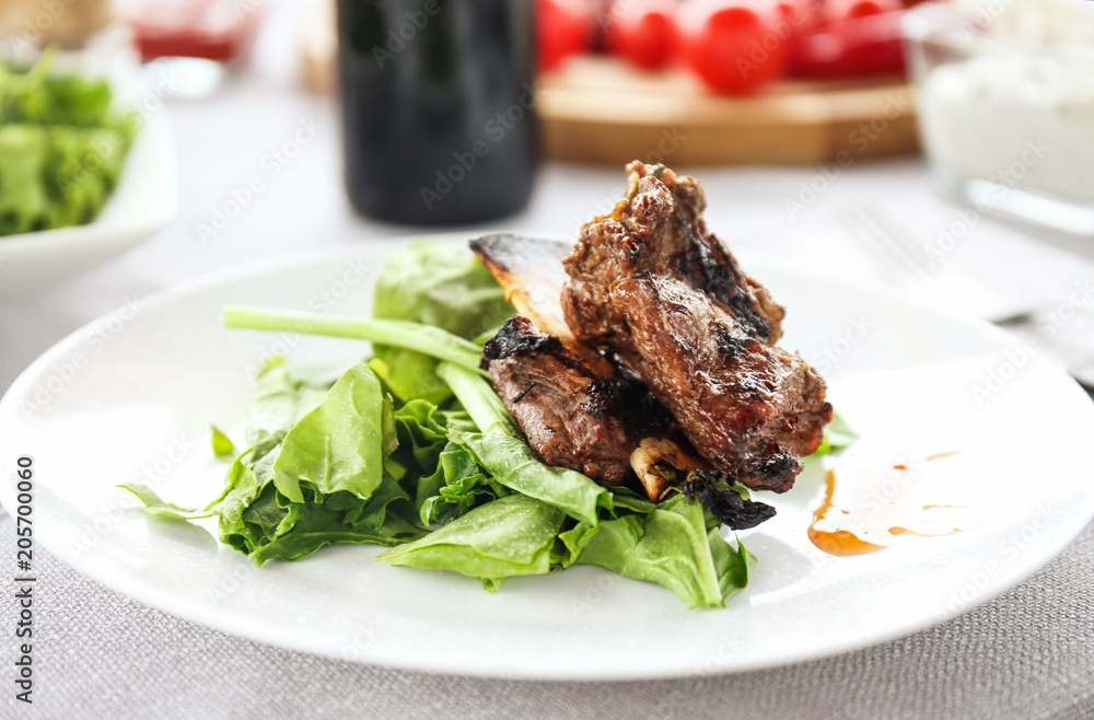 Delicious ribs served for dinner on table Delicious ribs served for dinner on table