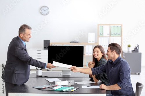 Young couple at notary publ...