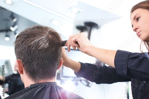 Female hairdresser with client in salon
