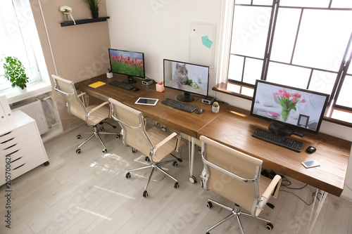 Stylish workplace interior with computers on tables © New Africa