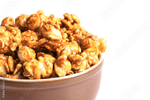 Delicious popcorn with caramel in bowl on white background