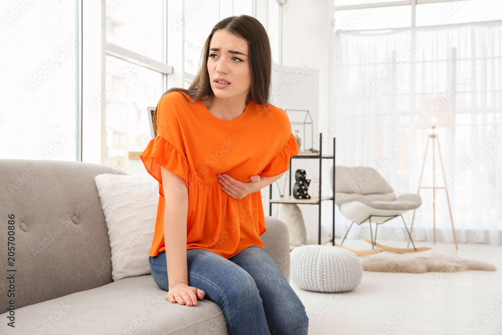 Young woman suffering from heart attack at home Young woman suffering from heart attack at home