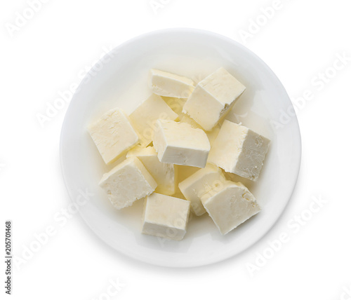 Plate with cubes of tasty fresh butter on white background, top view