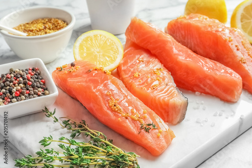 Fresh salmon and ingredients for marinade on marble board