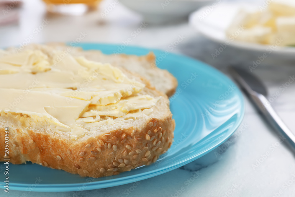 Fresh bread with tasty butter on plate