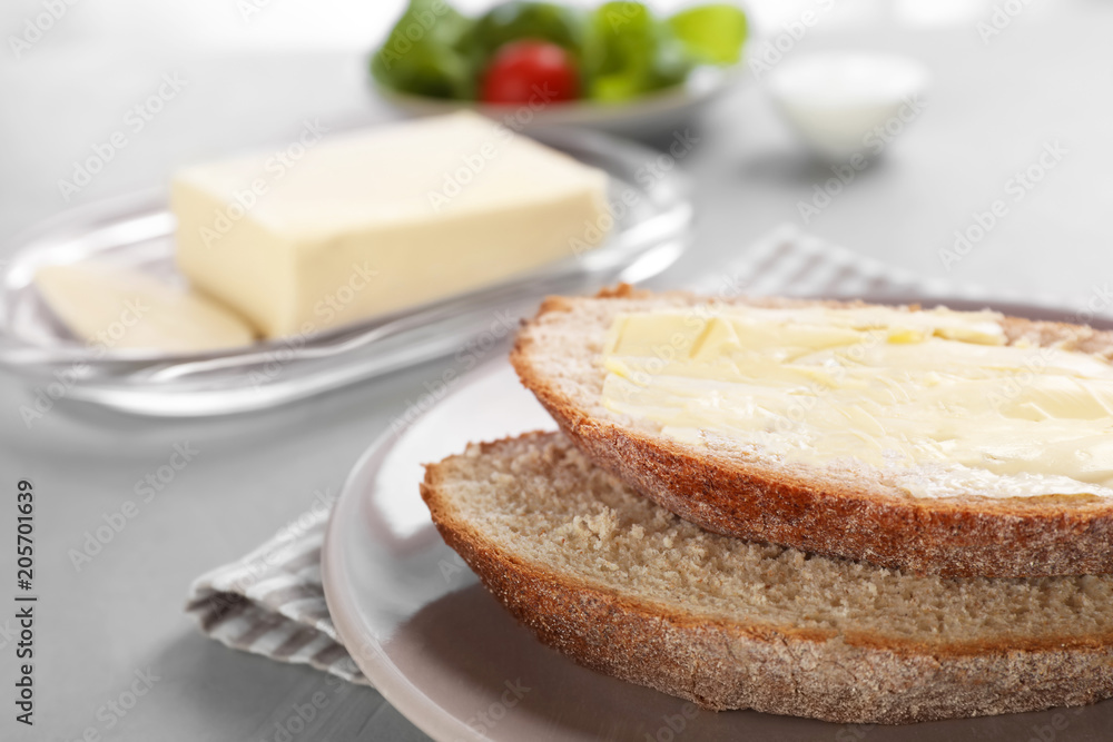 Fresh bread with tasty butter on plate Fresh bread with tasty butter on plate