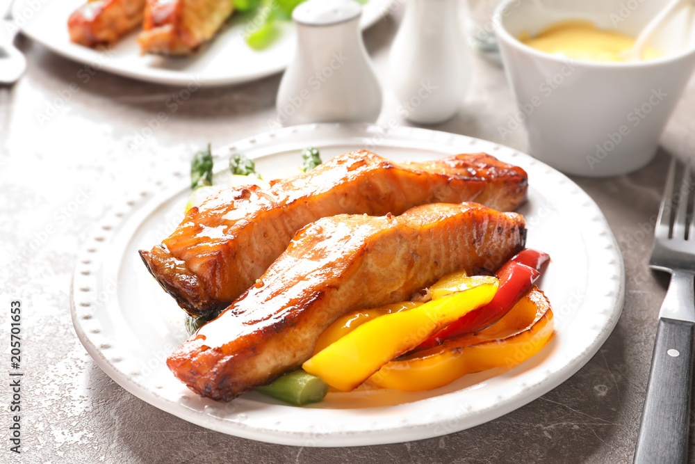Tasty cooked salmon with vegetables on plate Tasty cooked salmon with vegetables on plate