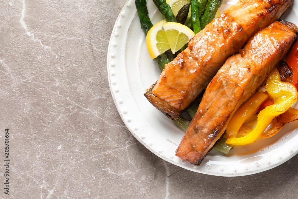 Tasty cooked salmon with vegetables on plate Tasty cooked salmon with vegetables on plate