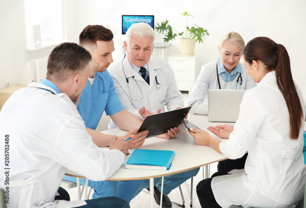 Group of doctors attending meeting in clinic. Cardiology conference Group of doctors attending meeting in clinic. Cardiology conference