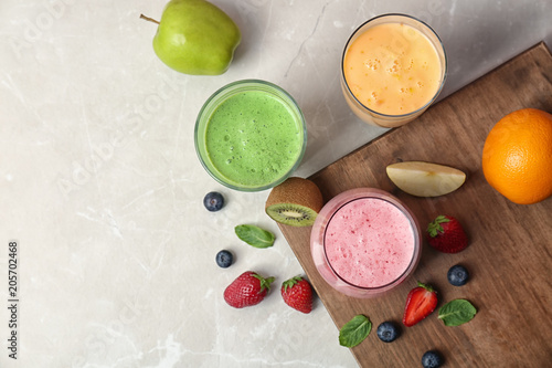 Flat lay composition with healthy detox smoothies and ingredients on light background