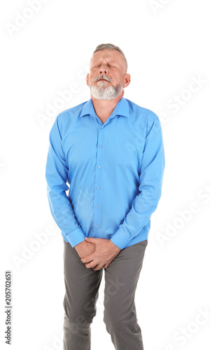 Mature man with urological problems suffering from pain on white background © New Africa