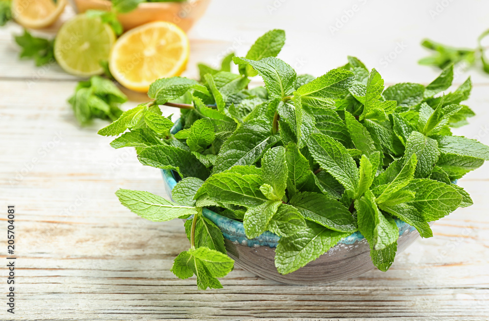 Bowl with fresh aromatic mint on table Bowl with fresh aromatic mint on table