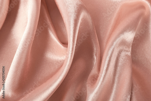 Texture of rose gold silk as background, closeup