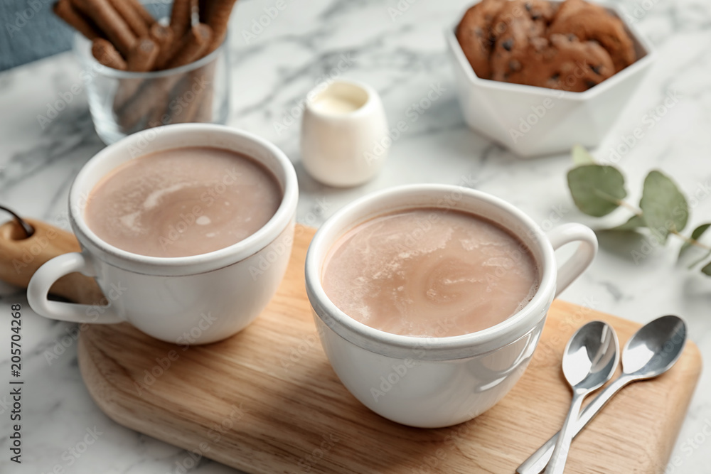 Cups with hot cocoa drink on table Cups with hot cocoa drink on table
