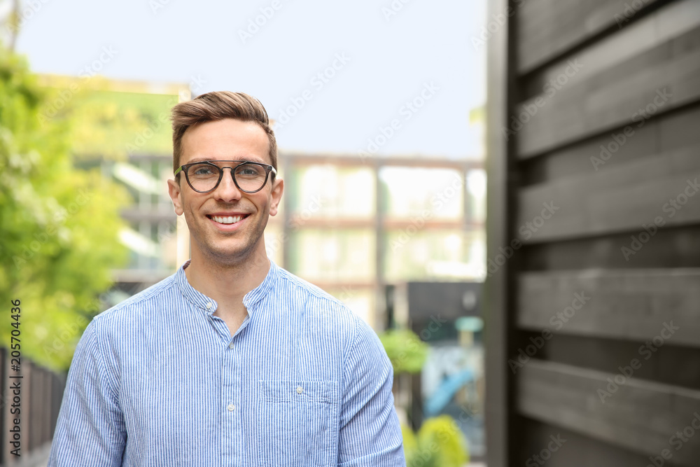 Obraz premium Portrait of attractive young man in stylish outfit outdoors