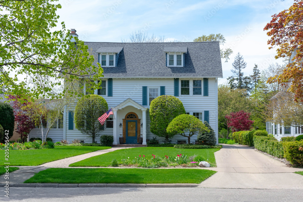 Front view of traditional colonial home with blue shutters