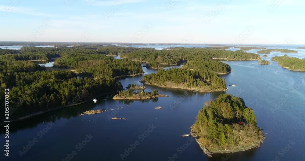 Saaristo, C4k aerial view above the finnish archipelago of islands, outside skaldo, on a sunny spring evening dawn, in Baggo, Uusimaa, on the gulf of Finland Saaristo, C4k aerial view above the finnish archipelago of islands, outside skaldo, on a sunny spring evening dawn, in Baggo, Uusimaa, on the gulf of Finland