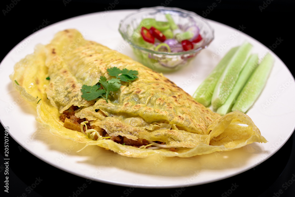Vietnamese food. Kanom Buang Yuan or Vietnamese stuffed crispy omelette served with Acar dipping sauce. selective focus. III Vietnamese food. Kanom Buang Yuan or Vietnamese stuffed crispy omelette served with Acar dipping sauce. selective focus. III