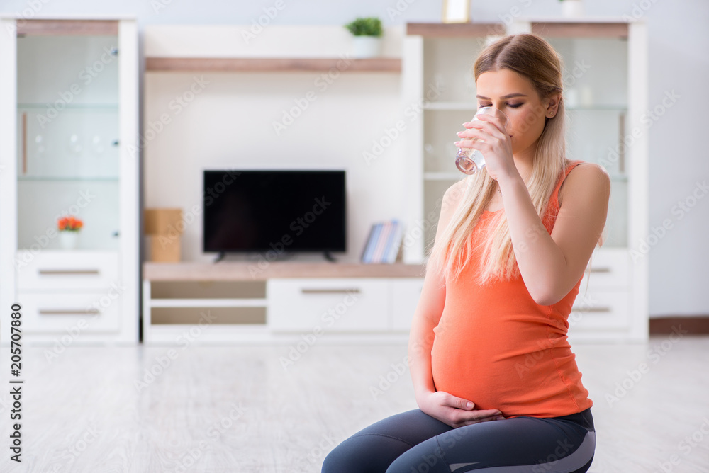 Pregnant woman doing sport exercise at home Pregnant woman doing sport exercise at home