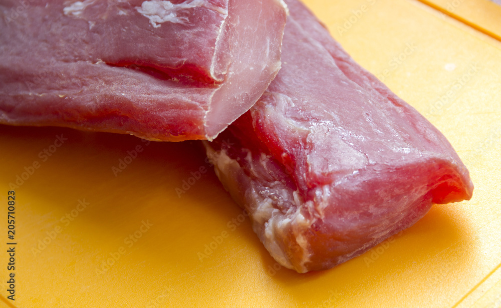 Raw meat. The pieces are on the cutting Board