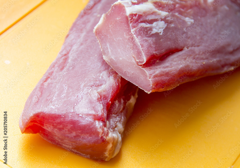 Raw meat. The pieces are on the cutting Board