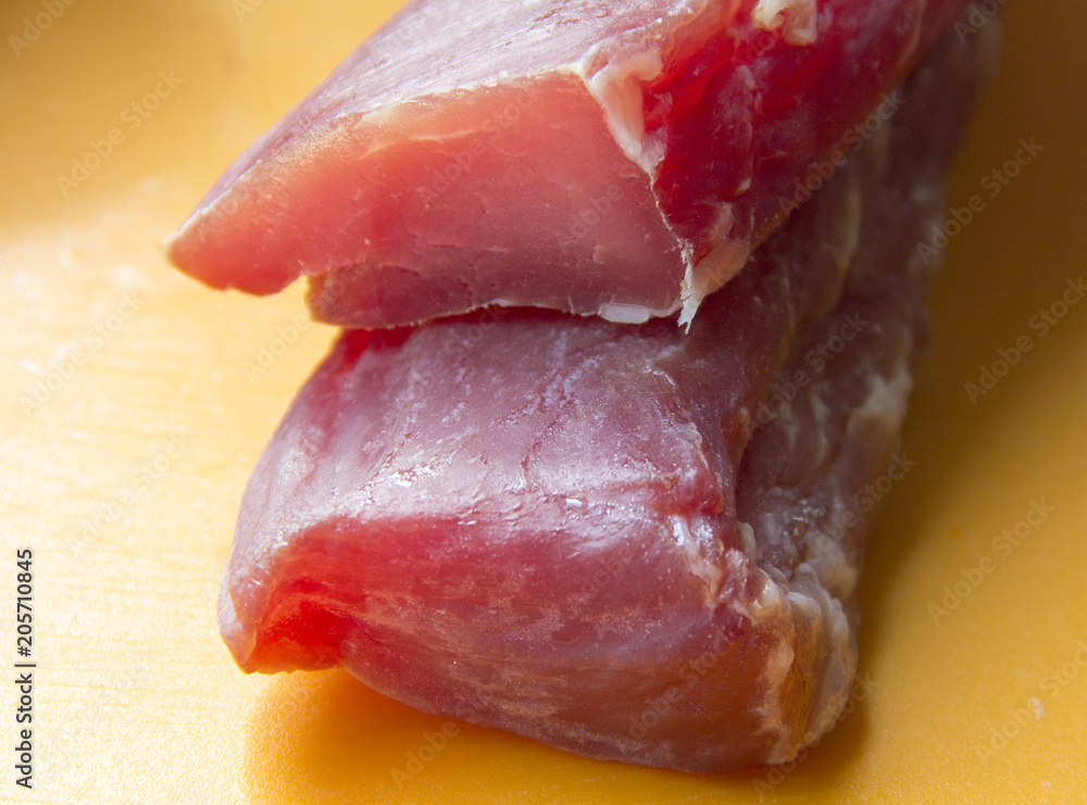 Raw meat. The pieces are on the cutting Board