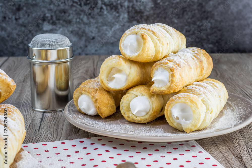 pyramid of a puff pastry creme rolle with cream (traditional Czech dessert)  Photos | Adobe Stock