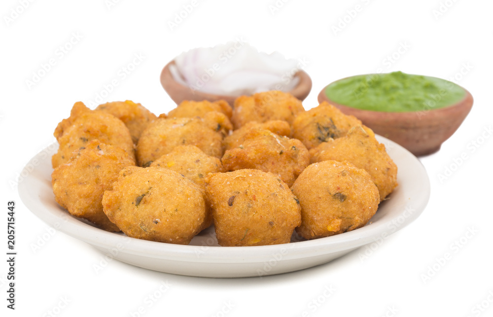 Indian Spicy Street Food Dal Vada Also Know as Moong Dal Vada, Pakoda, Pakode, Pakore, Moong Vada, Pakora or Bhajiya Served with Green Chutney or Onion isolated on White Background Indian Spicy Street Food Dal Vada Also Know as Moong Dal Vada, Pakoda, Pakode, Pakore, Moong Vada, Pakora or Bhajiya Served with Green Chutney or Onion isolated on White Background