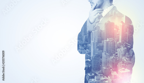 Businessman in suit standing thinking with metropolis graphic 