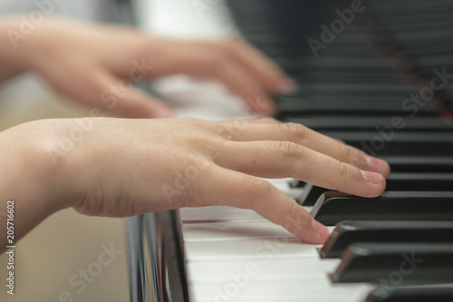 children's hands are playing the piano. Child's hand on piano keys.