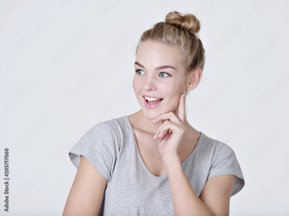 young thinking caucasian woman with finger near face young thinking caucasian woman with finger near face