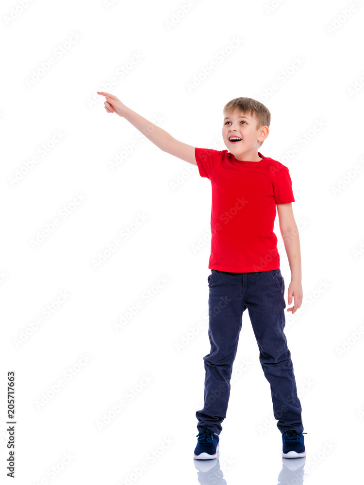 The boy points a finger at something. The boy points a finger at something.