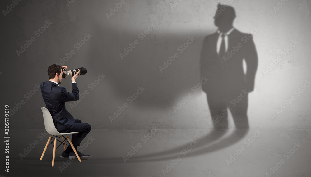 Humble businessman staying and offering stuffs to a huge angry bull shadow
Humble businessman staying and offering stuffs to a huge angry bull shadow