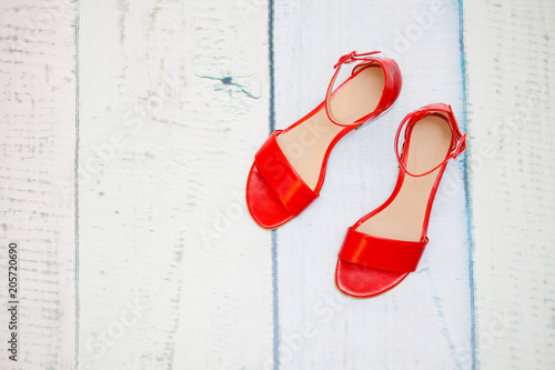 A pair of red sandals on the floor