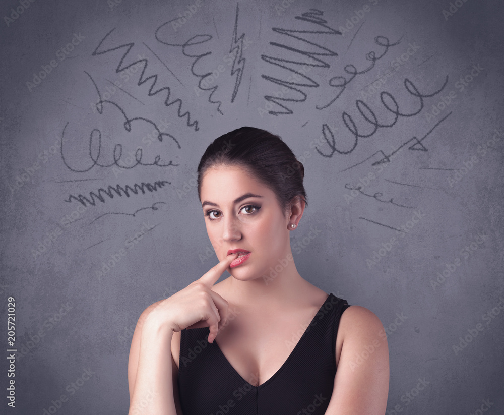 A cute female student making funny face expressions with pressure and problems in her head illustrated by drawn lines, marks and spirals on the urban wall background concept. A cute female student making funny face expressions with pressure and problems in her head illustrated by drawn lines, marks and spirals on the urban wall background concept.