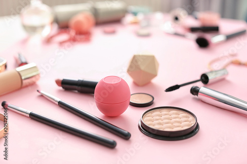 Makeup products for woman on color background