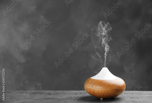Cuadro en lienzo Aroma oil diffuser on table against grey background