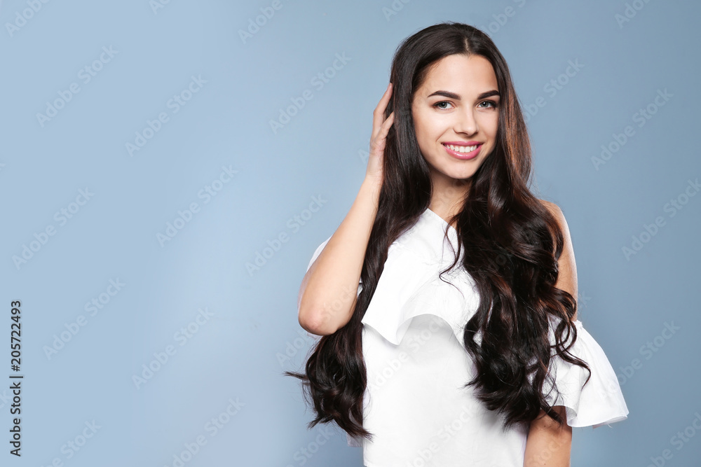 Portrait of beautiful model with gorgeous curly hair on grey background Portrait of beautiful model with gorgeous curly hair on grey background