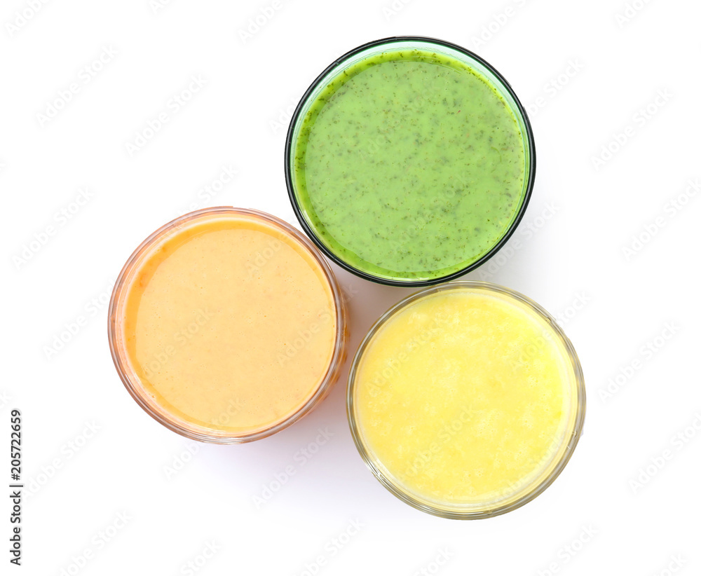 Glasses with delicious detox smoothies on white background, top view Glasses with delicious detox smoothies on white background, top view