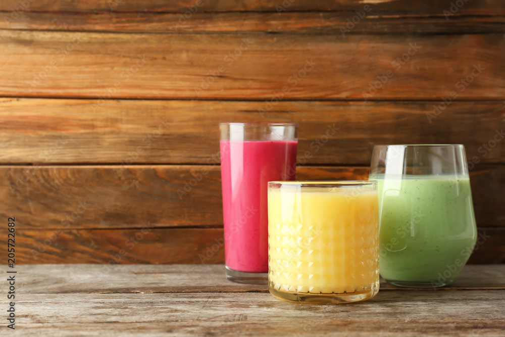 Glasses with delicious detox smoothies on table Glasses with delicious detox smoothies on table