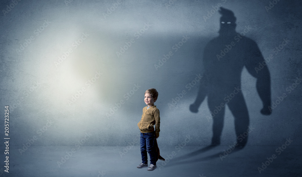 Cute kid in a room with plush on his hand and hero shadow on his background
Cute kid in a room with plush on his hand and hero shadow on his background